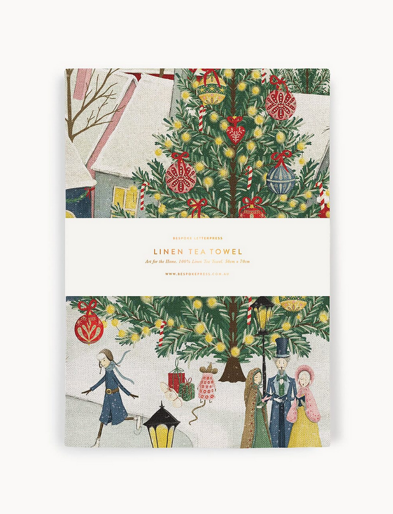 Linen tea towel packaging with Christmas tree and people design on a white background