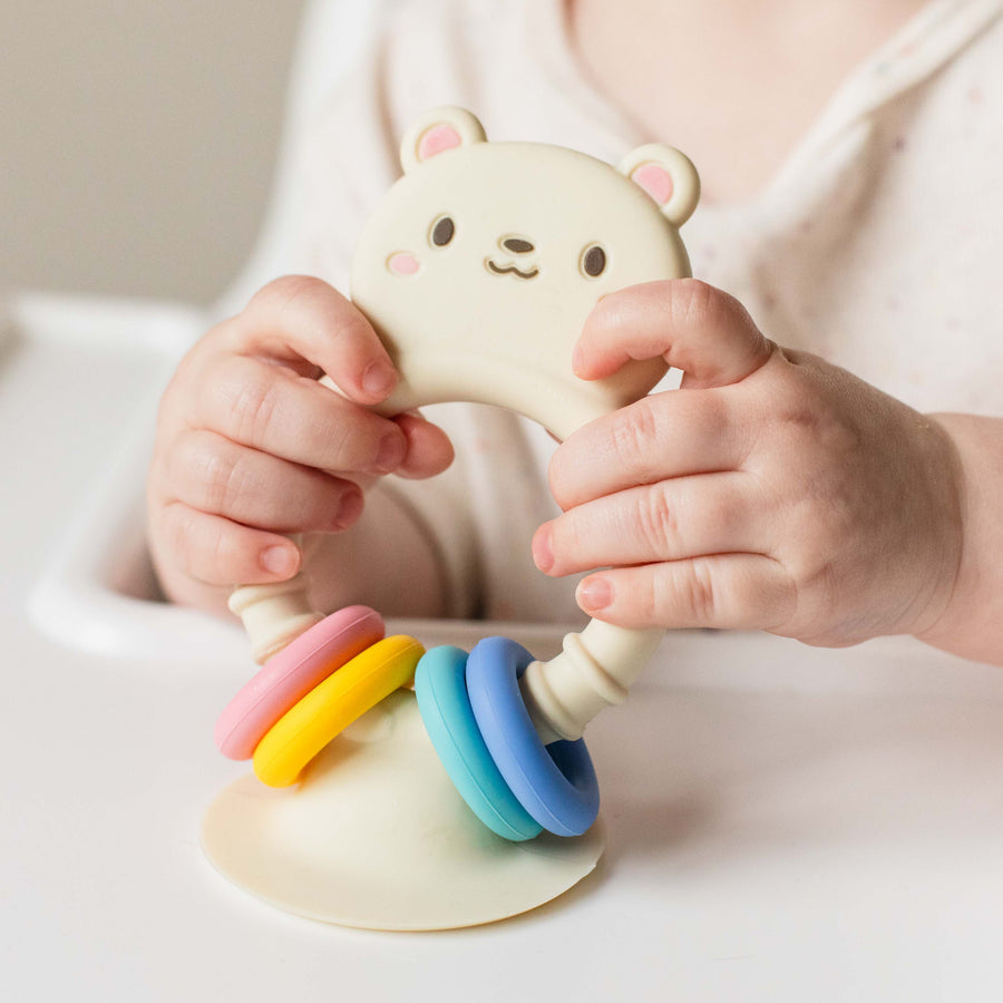 High chair buddy silicone bear toy packaging with colorful rings on a white background tiger tribe