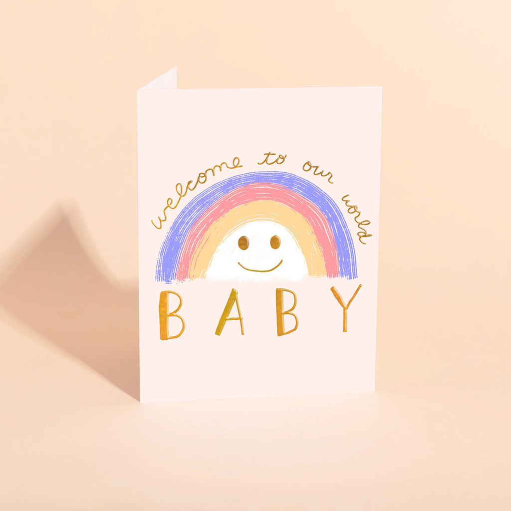 Greeting card with rainbow and baby text on a beige background