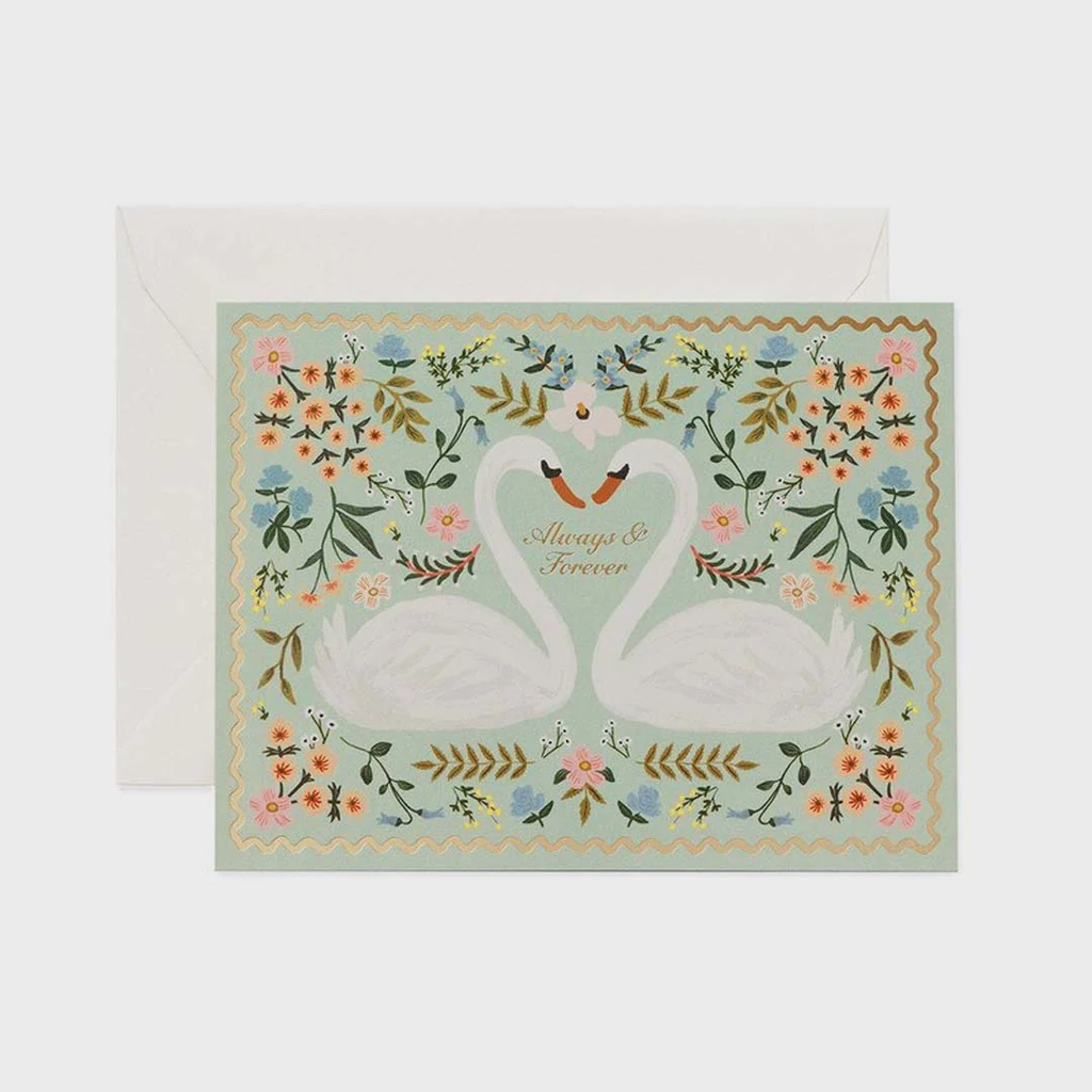 Greeting card with two swans and floral design on a light blue background rifle paper wedding
