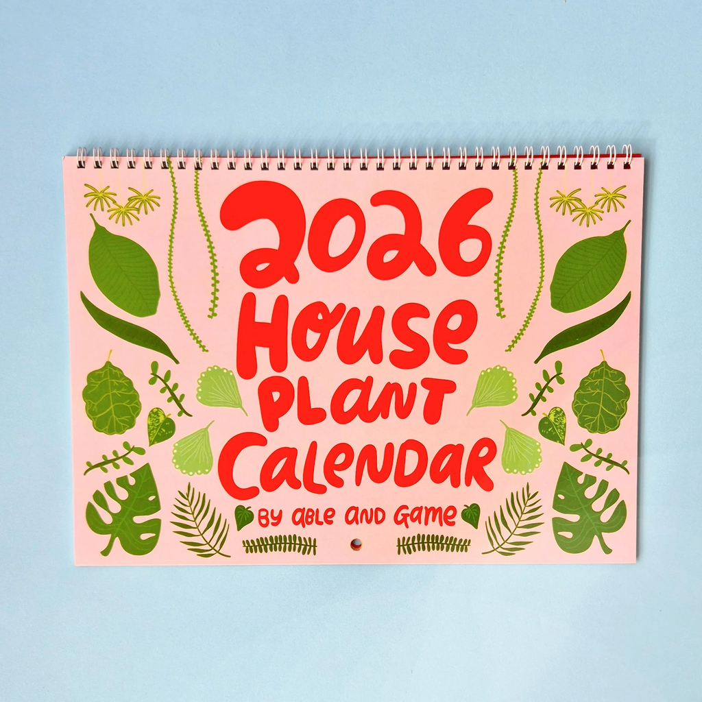 2026 House Plant Calendar with red text and green leaf illustrations on a pink background able game