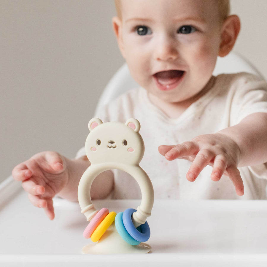 High chair buddy silicone bear toy packaging with colorful rings on a white background tiger tribe